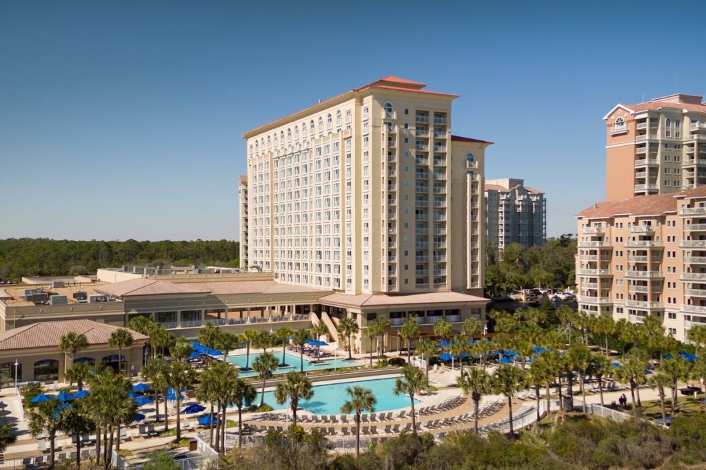 A picture of Marriot hotel at myrtle beach south carolina oceanfront with its building and pool in the focus 
